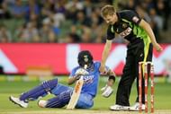James Faulkner of Australia helps Virat Kohli of India to his feet after he slipped